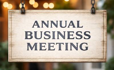 A sign that reads Annual Business Meeting in muted colors